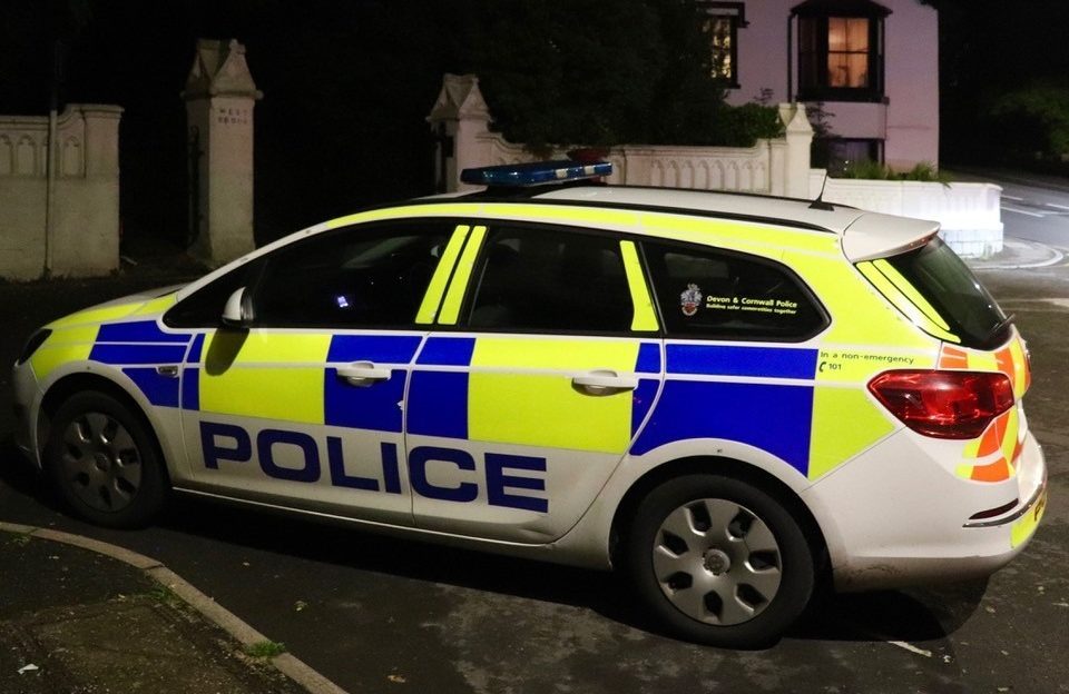 Police car parked at night on the street